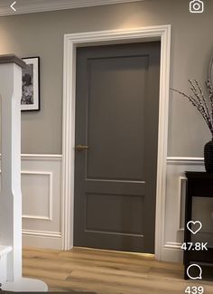 an image of a door in the middle of a room with pictures on the wall