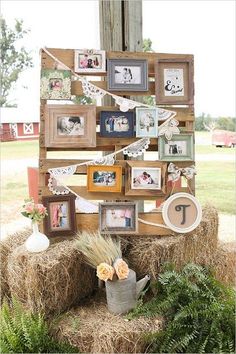 a hay bale with pictures on it and some flowers in a bucket next to the hay