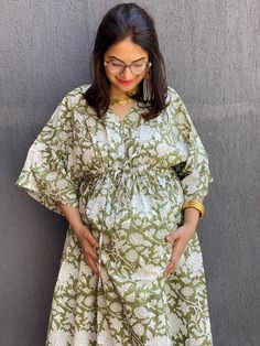 I have a deep fondness for crafting kaftans due to their unmatched comfort. This one is made with hand block printed cotton, adding a touch of uniqueness. This dress is designed with a drawstring waist and front buttons, making it perfect for expectant mothers and nursing. The flattering empire waist style suits not just pregnant women, but anyone looking for a comfy and stylish loungewear, getting ready, or house dress. You can also add pockets for an extra $5  www.etsy.com/listing/216227609/add-pockets-to-robeskaftans If you're in between sizes, consider sizing down, as the sizes are quite generous (e.g., Small-Medium fits one size, Large-XL, etc.). The shown length is ankle length, but I can customise it to knee or calf-length based on your height. You can select this option during chec Green Cotton Kaftan With Kimono Sleeves, Cotton Dresses With Block Print And Kimono Sleeves, Green Cotton Tunic Kaftan, Green Cotton Dress With Kimono Sleeves, Cotton V-neck Kaftan With Block Print, Dress For Pregnant Women, Stylish Loungewear, Maxi Robes, Caftan Dress