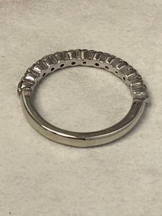 14kt White Gold Lady's Diamond Wedding/Anniversary/Stackable Band .38ct total weight consisting of 13- full cut round brilliant faceted diamonds all SI1 clarity, G color gem-lock bar precision set by our in-house Master Goldsmiths. This band is 2mm wide and has a finger size 6. This band would also make a GREAT Stackable. This item would Retail for $2,850.00 Anniversary Platinum Bands With Brilliant Cut, Anniversary Jewelry With Baguette Cut Lab Grown Diamond, Anniversary Baguette Cut Lab Grown Diamond Jewelry, Classic Silver Band With Vvs Clarity, Classic Silver Bands With Vvs Clarity, Moissanite Emerald Cut Eternity Band For Anniversary, Round Brilliant Cut Diamond Bands, Round Diamond Bands With Brilliant Cut, Moissanite Emerald Cut Anniversary Eternity Band