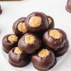 a white plate topped with chocolate covered donuts and peanut butter frosted on top