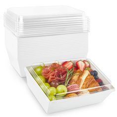 an open container filled with assorted fruits and meats on top of each other