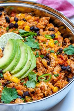 a bowl filled with rice, black beans and avocado