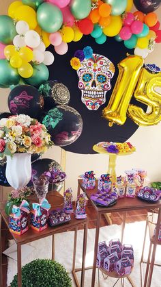 a table topped with lots of balloons and gifts