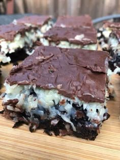 chocolate and coconut dessert bars on a cutting board