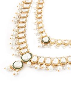 This jewellery set consists of a necklace, maangtika and a pair of earringsGold-plated layered necklace, has white & Green Kundan stone-studded & Pearls beaded detailsSecured with a drawstring closureA pair of matching drop earrings, each secured with a post-and-back closureMatching maangtika secured with hook closure Size & Fit Necklace Length-51 cmEarring Length-8 cm EachMaangtikka Length-12 cmProduct Weight-179 grams Material & Care Material: AlloyPlating: Gold-platedStone Type: Kundan & PearlsCare InstructionWipe your jewellery with a soft cloth after every useAlways store your jewellery in a flat box to avoid accidental scratchesKeep sprays and perfumes away from your jewelleryDo not soak your jewellery in waterClean your jewellery using a soft brush, dipped in jewellery cleaning solu Festive White Jewelry, White Chandbali Necklace For Festive Occasions, White Bollywood Necklaces For Festive Occasions, White Bollywood Necklace For Festive Occasions, Festive White Stone Work Necklaces, Festive White Stone Work Necklace, Festive White Bollywood Necklace, White Bollywood Necklaces With Latkans, White Bollywood Necklace With Stone Work