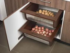 an open drawer in a kitchen filled with potatoes