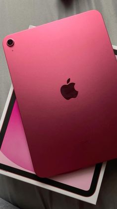 two pink ipads sitting on top of each other