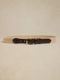 Rugged yet refined, this timeless belt has a utilitarian feel, made modern and more elevated by juxtaposing sturdy cotton webbing against luxurious leather accents.  Width: 1. 75" Classic Beige Leather Belt, Classic Adjustable Fabric Belt, Classic Beige Belts For Formal Wear, Classic Beige Belts For Formal Occasions, Classic Leather Belt With Leather Trim, Summer 2025, Family Event, Leather Accents, Canvas Leather