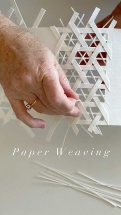 a person is holding paper weaving in their hand with the words paper weaving on it