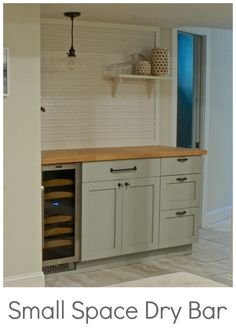 a small space dry bar in the middle of a room with shelves and cabinets on either side