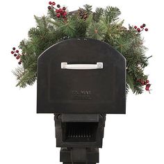 a black mailbox with evergreen and red berries on it