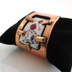 A vintage marked "Matisse" solid copper cuff bracelet with enameled panel of white, burgundy, copper, and greens.  The copper surface has noticeable scratches and wear -I also haven't polished it at all.  1 5/8" at widest point.  Currently 2 3/8" inner diameter.  Copper is 5 1/2" in length with 1 3/8" gap.  Bendable. Please check out my store with similar things added almost daily. Remember, shipping for additional items is always free. Copper Cuff Bracelet, Copper Cuff, Bracelet Vintage, May 13, Cuff Bracelet, Cuff Bracelets, Gap, Jewelry Bracelets, Copper