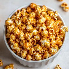 a white bowl filled with caramel popcorn