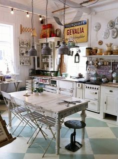 an old fashioned kitchen with white cabinets and checkered flooring on the floor is shown