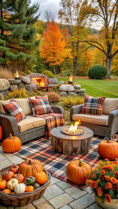 an outdoor fire pit surrounded by furniture and pumpkins