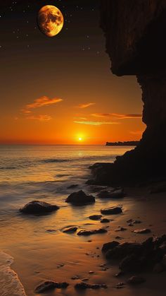 the sun is setting over the ocean with rocks on the shore and water in front of it