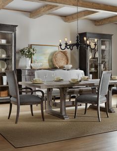 a dining room table with chairs and a china cabinet