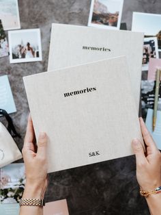 two hands holding up a book with the title memories written on it, surrounded by photos