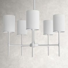 a white chandelier with five lamps hanging from it