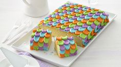 there is a cake that has been decorated with multicolored icing on it