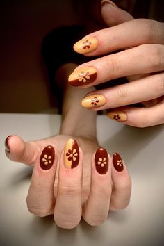 Channel the cozy vibes of autumn with retro-inspired nail art! Think warm fall hues like mustard yellow, burnt orange, and earthy browns paired with 70s-inspired patterns like swirls, checkerboards, and florals. Perfect for anyone who loves a vintage aesthetic with a modern twist. Add a groovy touch to your fall look with these nostalgic nail designs, and get ready to step back into style! #RetroNails #FallNailTrends 70s Nail Art Design, Retro Fall Nail Designs, Retro Fall Nails, 70s Nails Retro Short, 70s Nails Retro Fall, Orange Retro Nails, 70’s Nail Designs, Brown And Orange Nails, 70s Nail Art