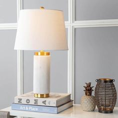 a table with a lamp and some books on it