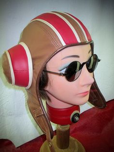 Custom made-to-order genuine leather aviator inspired by the Psychonauts/ Razputin videogames.  Super- soft brown and red lambskin leather with comfy quilted lining and foam- padded earcups.  Solid brass buckle and brown goggle holder button.   Features "tunnels" under earcups for your goggle straps to pull through to back of hat.  This listing is for a 'MADE TO ORDER" Leather Razputin Aviator!  Turnaround time is 2-3 weeks(excluding ship time) upon purchase.  PLEASE give your exact head size(see diagram), and any special instructions regarding color changes for leather/ hardware.  Care:  Apply leather conditioner twice a year. Dry- cleaning NOT recommended!  If soaked wet, air- dry away from direct sun or heat sources. "Leatherhead" is the only known person(me) that makes Razputin's aviat Retro Brown Leather Hat, Aviator Hat, Soaking Wet, Leather Gear, Leather Conditioner, Pull Through, Brass Buckle, Lambskin Leather, Vintage Leather