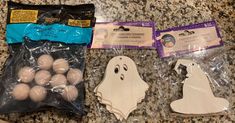 two bags of white plastic ghost and one bag of eggs in the shape of a ghost