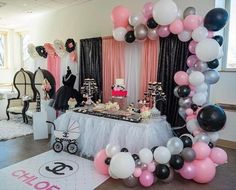 a birthday party with balloons, cake and decorations