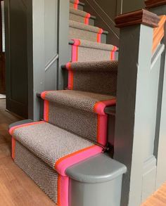 a set of stairs with pink and grey trim