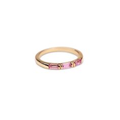 14k Gold Triple Pink Sapphire Baguette Ring Our new colorful 14k Pink Sapphire Baguette Ring will be a simplistic yet modern addition to your ring collection. Featuring three stunning, genuine and ethically sourced Pink Sapphires Baguettes Band thickness: 2mm Handset in our Los Angeles studio. Built to last a lifetime and more. Please allow 1 - 2 weeks for processing on our solid gold and diamond pieces. Pink Wedding Band, Sapphire Baguette Ring, Sapphire Gold Ring, Pink Sapphire Band, Baguette Band, Baguette Wedding Band, Gold Moonstone Ring, 14k Gold Wedding Ring, Baguette Ring