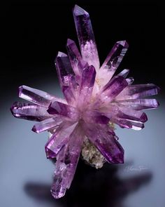 a cluster of purple crystals sitting on top of a table