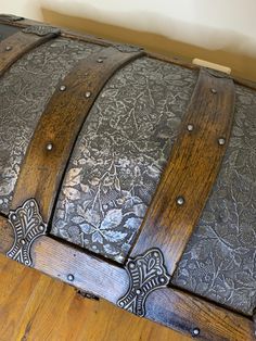 an old wooden trunk sitting on top of a hard wood floor