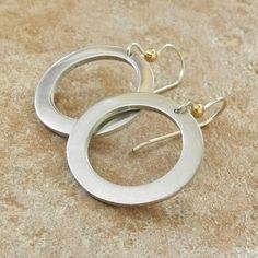 "Sterling Silver Handmade Hoop Earrings - Thick Hoop Earrings - Silver and Gold Hoops - PMC Sterling Earrings These thick hoop earrings were hand formed from 960 sterling silver clay after which they were kiln-fired, tumbled, and hand polished to a gleaming satin finish! Because of the hand construction of the hoops, each has a slightly different shape and character lending them an organic appeal. They hang from sterling silver earwires and are accented with a gold filled bead at the top. These Modern Nickel Free Round Earrings, Modern Nickel-free Round Earrings, Single Circle Earring For Anniversary, Gift Single Open Circle Earring, Metal Open Circle Earrings, Gift Single Open Circle Hoop Earring, Modern Handmade Small Hoop Earrings, Everyday Metal Open Circle Earrings, Metal Open Circle Earrings For Everyday