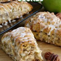 an apple pecan scones is cut in half and sitting on a cutting board