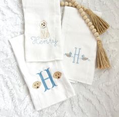 three personalized towels with embroidered animals on them