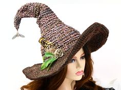 Ready for the Renfaire, a Steampunk festival, cosplay, a witch gathering, your table centerpiece, or just plain fun, this witch hat is firmly structured but soft to wear. Ready to navigate the forest or the sea, I've done this one with a bit of mariner steampunk and just a touch of forest. A steampunk style firefly dangles from the tip to light your way in the dark, with an octopus wrapped around an anchor at the base, and some ferns and feathers tucked behind. The way I stitch allows you to twist and shape or return it to straight up. The wired brim can also be shaped in any number of ways. When you're not wearing it, you can toss it on your table for a great conversational centerpiece, or hang it on a hook by the door! Folds flat for your travels. -This soft witchy hat has some stretch s Witch Gathering, Steampunk Magic, Nautical Steampunk, Steampunk Witch, Steampunk Festival, Wizard Hat, Magic Hat, Steampunk Style, Costume Hats