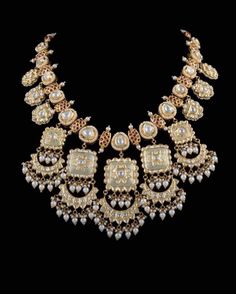 an elaborate necklace with pearls and stones