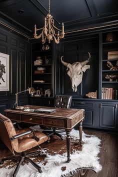 a desk with a chair and a cow skull on the wall in front of it