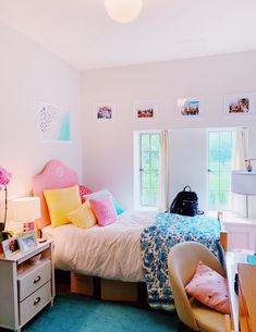 a bed room with a neatly made bed next to a dresser and window sill