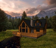 a house in the middle of a field with mountains in the background