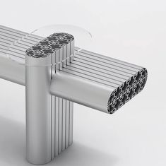 a bench made out of metal pipes with black and white designs