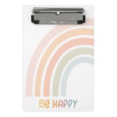 a clipboard with the words be happy on it and a rainbow in the background