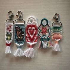 four key chains with tassels hanging from them