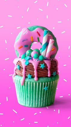 a birthday cupcake with pink frosting and sprinkles on it's top