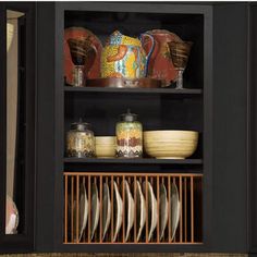 an open cabinet filled with dishes and plates