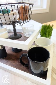 two coffee mugs sitting on top of a tray