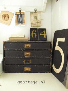 an old chest with numbers and pictures on the wall next to a clock that reads 64