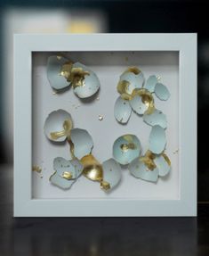 some white and gold pieces in a white frame